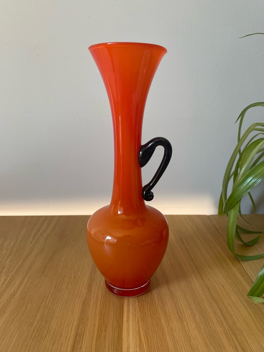 Vintage MCM Orange Art Glass Vase with Black Handle 8โ
